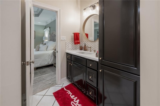 bathroom featuring decorative backsplash, tile patterned flooring, vanity, and ornamental molding