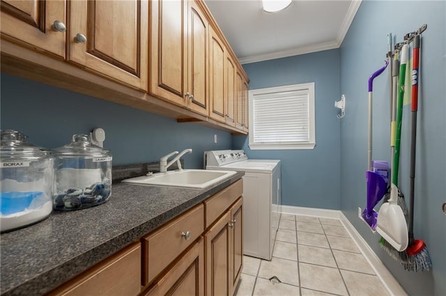 washroom with washer and clothes dryer, cabinets, crown molding, sink, and light tile patterned floors