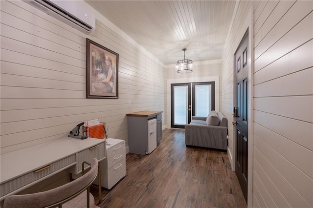 hallway with french doors, dark hardwood / wood-style floors, a wall unit AC, wood walls, and a chandelier