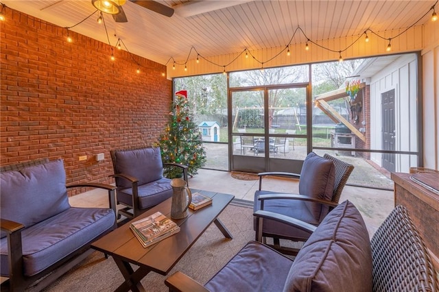 sunroom / solarium featuring wood ceiling, a wealth of natural light, and ceiling fan