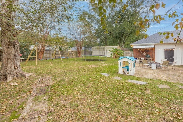 view of yard featuring a playground, a patio area, and a trampoline