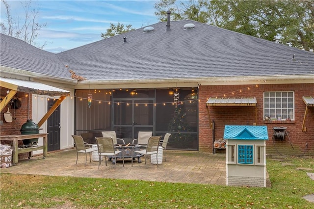 rear view of house featuring an outdoor fire pit and a patio