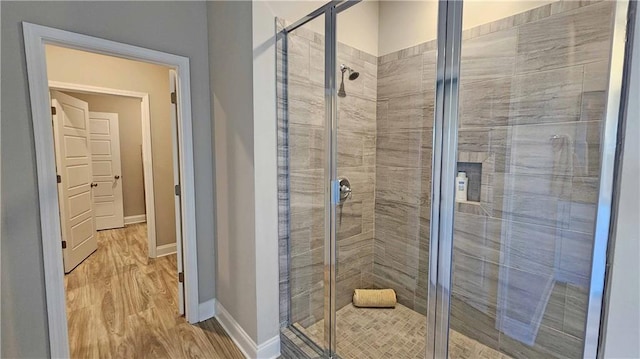 bathroom with hardwood / wood-style floors and walk in shower