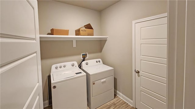 laundry room with separate washer and dryer and light wood-type flooring