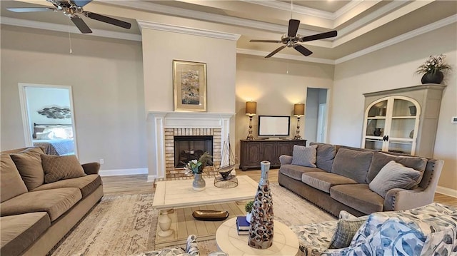 living room with a fireplace, crown molding, and light hardwood / wood-style flooring