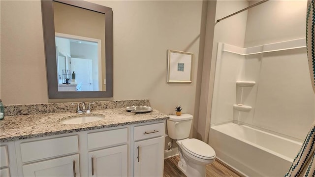 full bathroom featuring vanity, toilet, wood-type flooring, and shower / tub combination