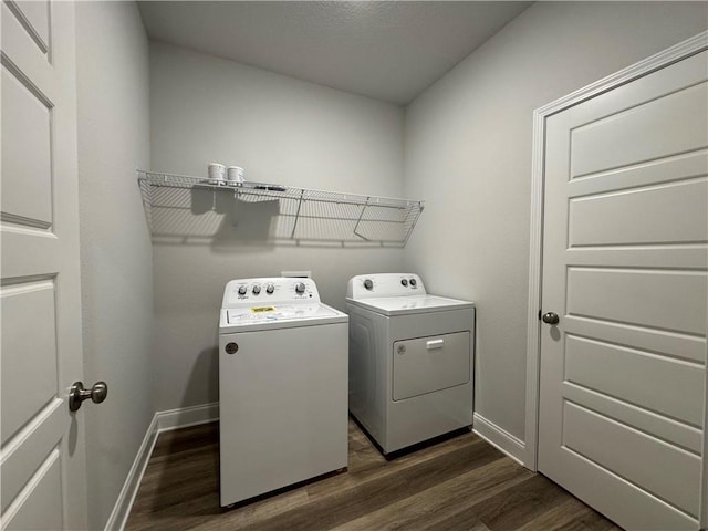 clothes washing area featuring dark hardwood / wood-style floors and independent washer and dryer