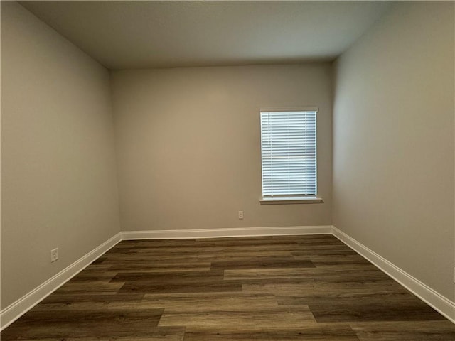 unfurnished room featuring dark wood-type flooring