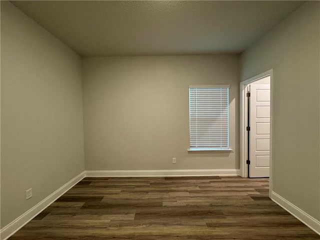 unfurnished room featuring dark wood-type flooring