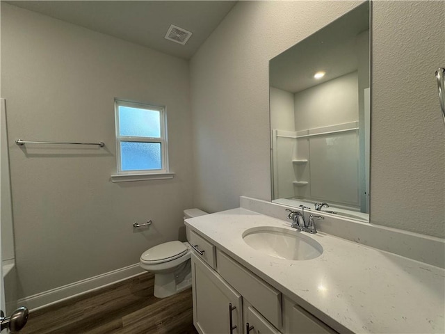 bathroom featuring toilet, vanity, and hardwood / wood-style flooring