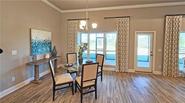 dining space with a chandelier, hardwood / wood-style flooring, and ornamental molding