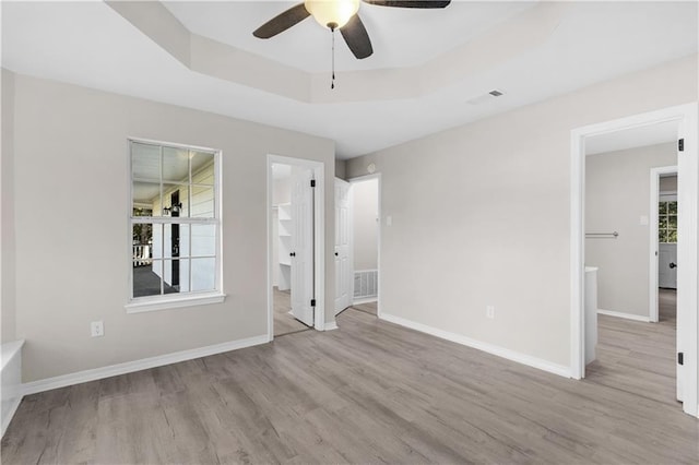 spare room featuring ceiling fan, plenty of natural light, and light wood-type flooring