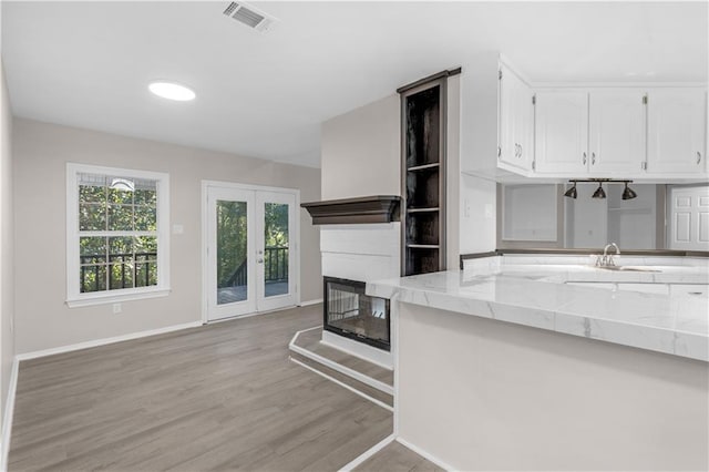 living room featuring french doors and light hardwood / wood-style flooring