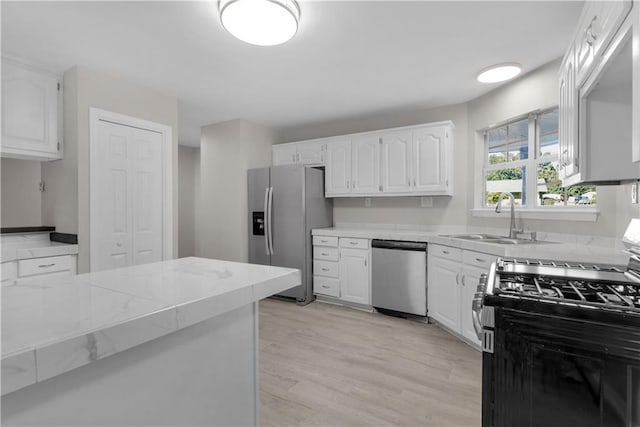 kitchen with sink, white cabinets, and appliances with stainless steel finishes