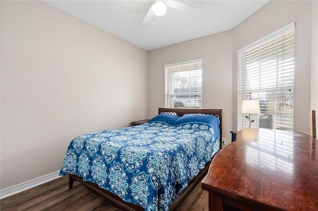 bedroom with ceiling fan, baseboards, and wood finished floors