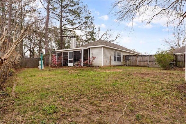 view of yard with a fenced backyard and a sunroom