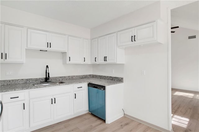 kitchen with sink, white cabinets, dishwashing machine, light stone counters, and light hardwood / wood-style flooring