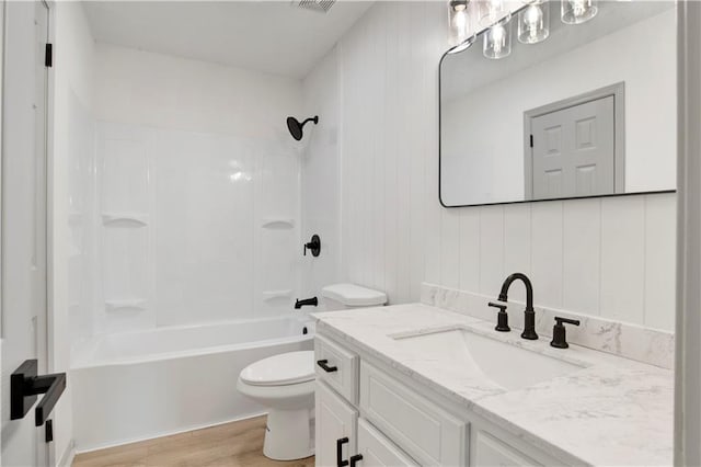 full bathroom with shower / bathtub combination, vanity, toilet, and hardwood / wood-style floors