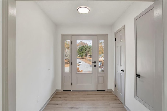 doorway to outside with light wood-type flooring