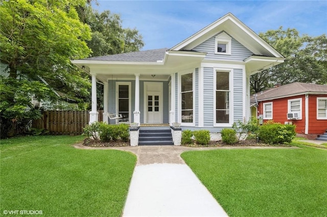 view of front of house featuring covered porch and a front yard