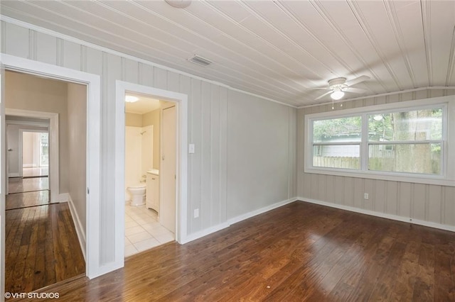 unfurnished room with hardwood / wood-style flooring, ceiling fan, and a wealth of natural light