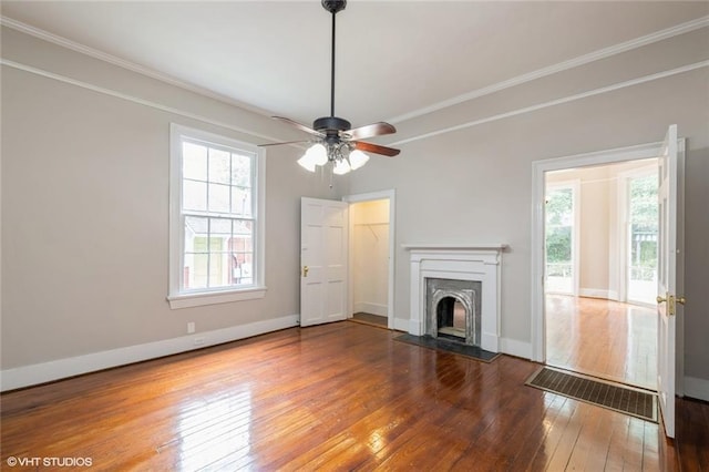 unfurnished living room featuring hardwood / wood-style floors, ceiling fan, crown molding, and a high end fireplace