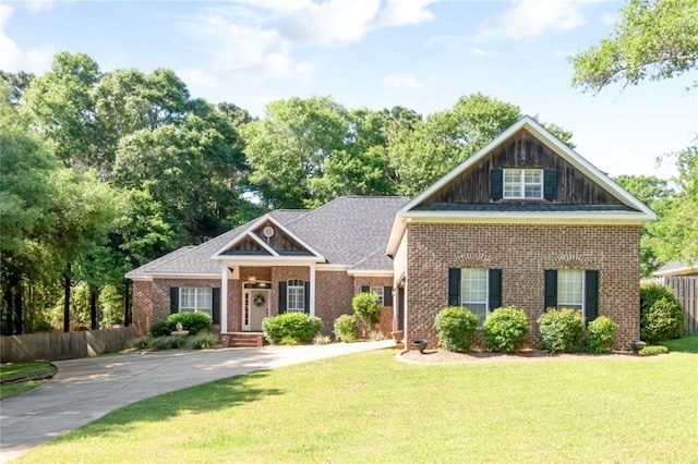 8814 Dawes Lake Rd N, Mobile, AL 36619 - craftsman-style home with brick siding, driveway, fence, and a front yard