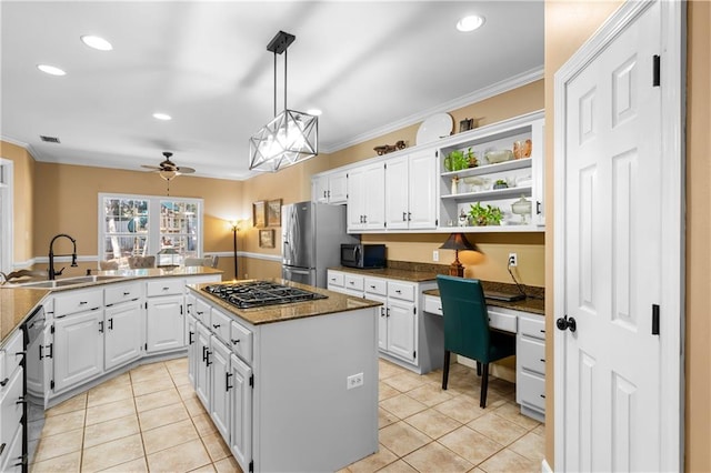 kitchen with ornamental molding, sink, a center island, white cabinetry, and appliances with stainless steel finishes