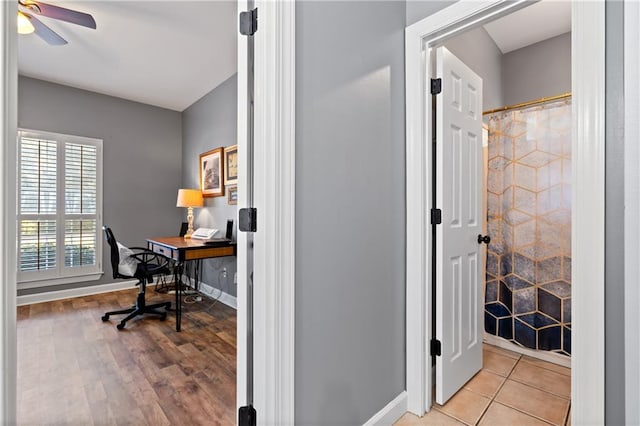 office with light hardwood / wood-style floors and ceiling fan