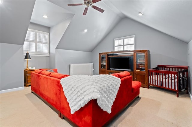 bedroom with ceiling fan, light carpet, and vaulted ceiling