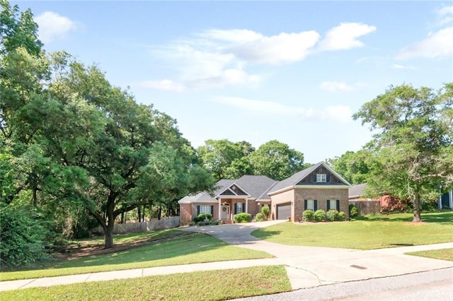 8814 Dawes Lake Rd N, Mobile, AL 36619 - view of front of house with a garage, fence, a front lawn, concrete driveway, and brick siding