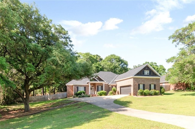 8814 Dawes Lake Rd N, Mobile, AL 36619 - view of front of property featuring fence, a garage, brick siding, and driveway