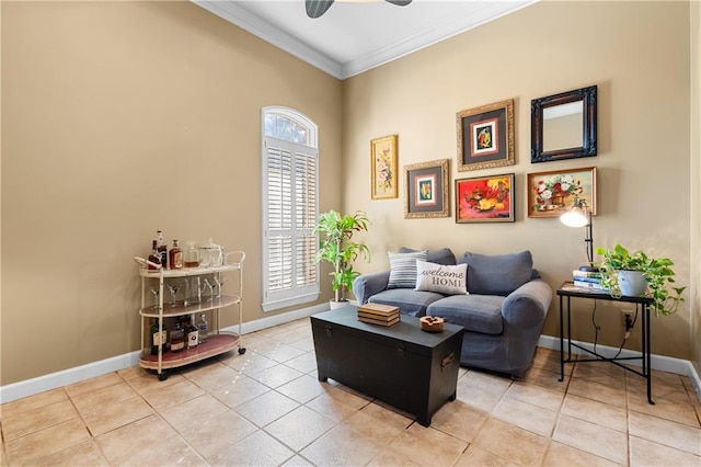 living area with crown molding, ceiling fan, tile patterned flooring, and a wealth of natural light