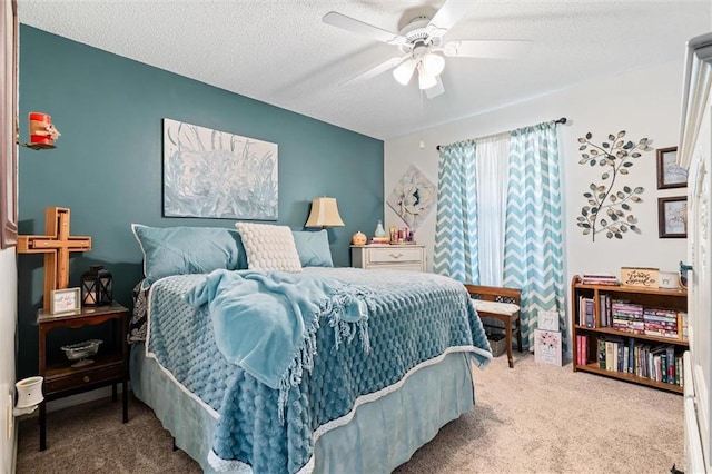 carpeted bedroom featuring a ceiling fan and a textured ceiling