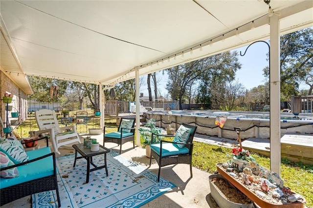 view of patio featuring a covered pool, a fenced backyard, and an outdoor hangout area