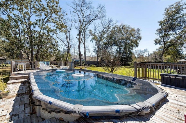 view of swimming pool with a wooden deck