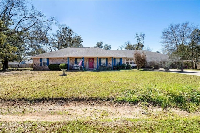 ranch-style home with a front yard and brick siding