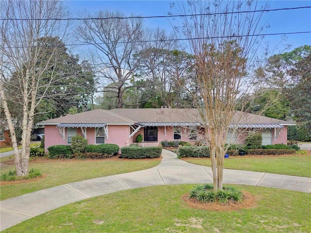 ranch-style house with a front lawn