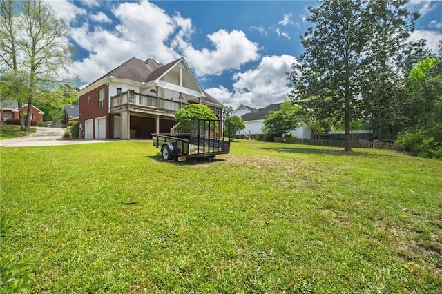 3424 Windsor Place Ct, Mobile, AL 36695 - view of green lawn with an attached garage, concrete driveway, and a wooden deck