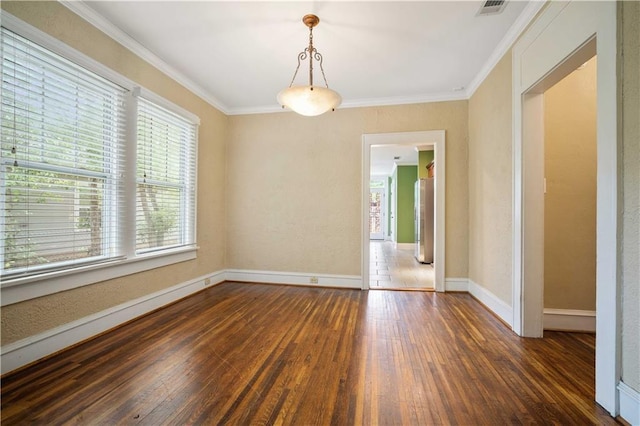 603 Glenwood St, Mobile, AL 36606 - spare room featuring dark wood-type flooring, crown molding, and baseboards