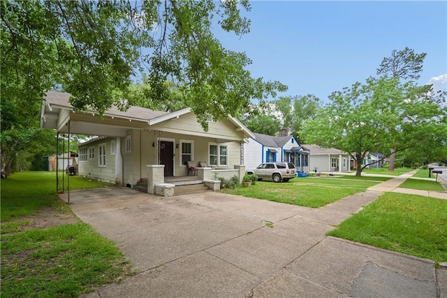 603 Glenwood St, Mobile, AL 36606 - view of front of house with an attached carport, covered porch, a front lawn, and driveway