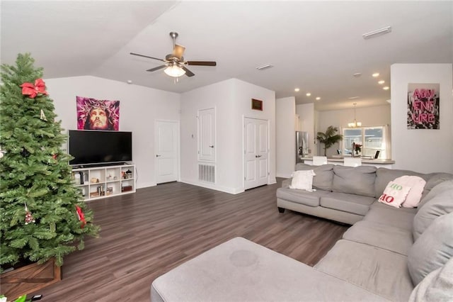 living room featuring dark hardwood / wood-style floors, lofted ceiling, and ceiling fan with notable chandelier