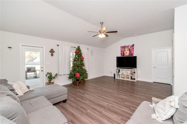 living room featuring hardwood / wood-style floors, ceiling fan, and vaulted ceiling