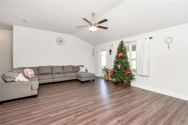 living room with ceiling fan, lofted ceiling, and hardwood / wood-style flooring