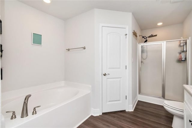 full bathroom with wood-type flooring, vanity, toilet, and independent shower and bath