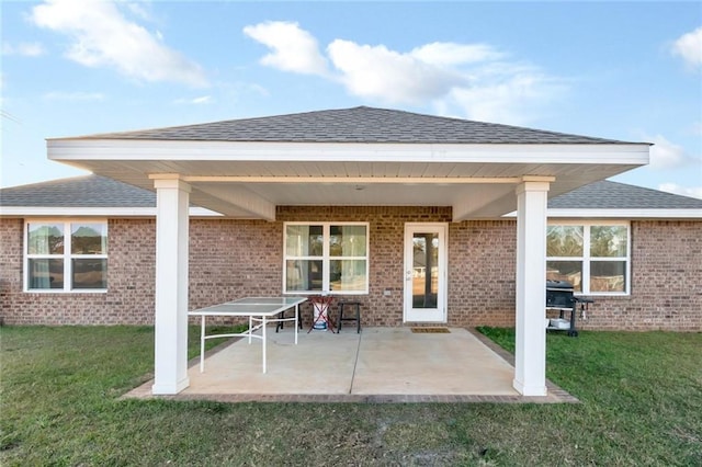 back of house featuring a lawn and a patio