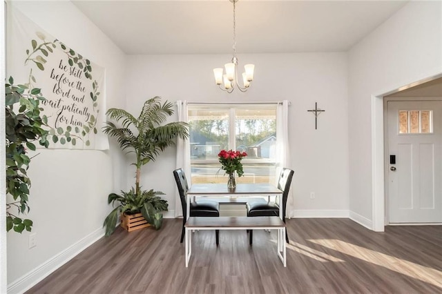 dining room featuring dark hardwood / wood-style flooring and an inviting chandelier