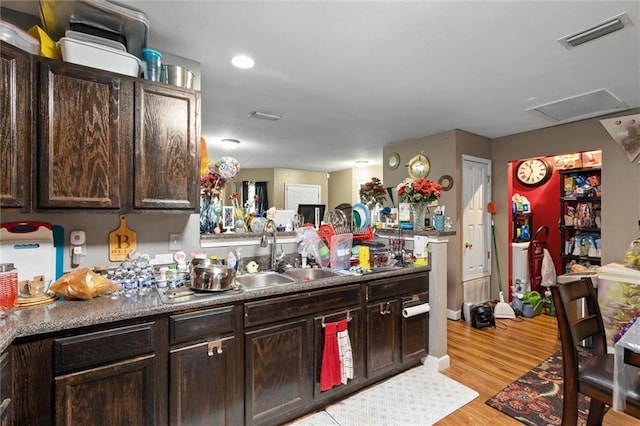 505 Doby Ct, Mobile, AL 36608 - kitchen featuring dark brown cabinetry, light wood-style flooring, and recessed lighting