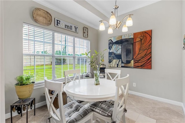 tiled dining space featuring a chandelier and ornamental molding