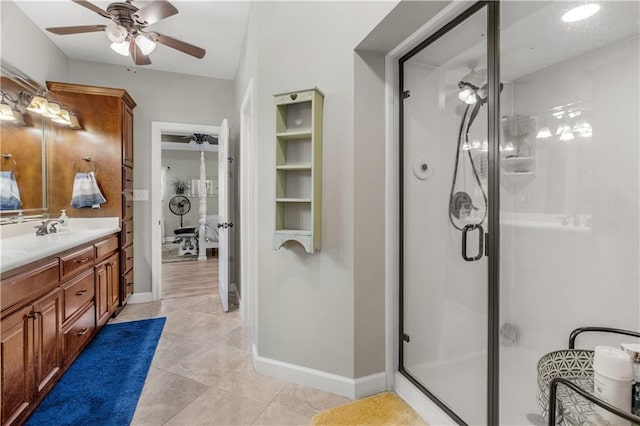 bathroom featuring tile patterned floors, vanity, ceiling fan, and a shower with door